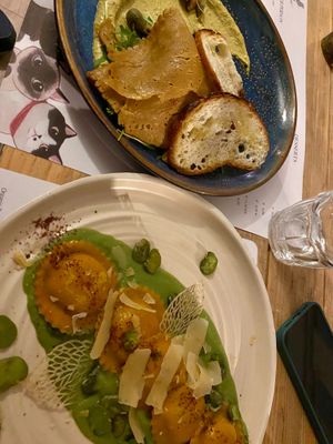 Sliced seitan dish and ravioli at Romeow Cat Bistrot in Rome
