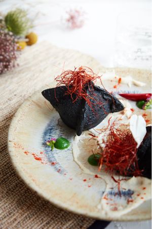 Saccottino ripieno di olive, scarola e uvetta con crema di mandole at Romeow Cat Bistrot in Rome