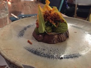 Roasted eggplant with Brazilian nuts and basil cream, marinated courgettes, courgette flowers and carrot chips at Romeow Cat Bistrot in Rome
