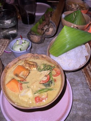 yellow curry with tofu, sweet potato and other vegetables. comes with rice and cucumber salad  at Mezzanine in Tulum