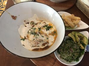 Shakshuka lunch which comes with fries and tabouli. Portion is very very small but tasty. COP 35,0000    at Ikaro Cafe in Santa Marta