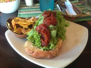 Home baked bread with humus, juicy sun-dried tomatoes and banana chips ?  at Ikaro Cafe in Santa Marta