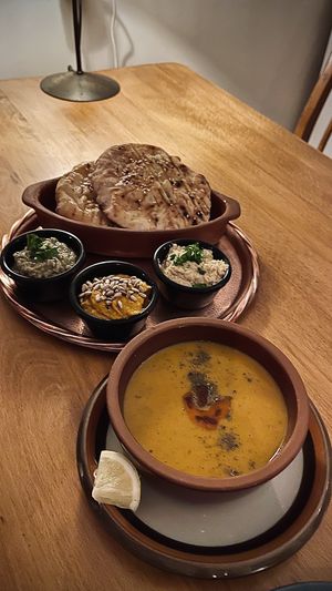 Lentil soup with small babaghanoush, roasted carrot dip, and hummus. Fresh pita was complementary, €5 total for everything here.  at Babaghanoush in Pristina