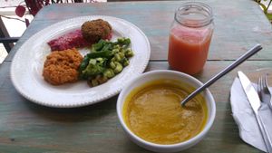Tropical fruit juice; pureed pumpkin soup; beet hummus, fritter, quinoa with sauce, green veg salad at Chana Plant Based in Medellin