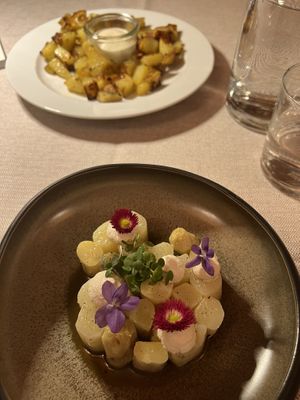 Asparagus with edible flowers (baked potatoes with vegan mayonnaise in the background )  at Al Tiglio Cucina Naturale in Moruzzo