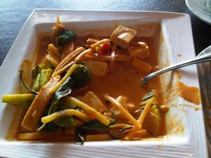 Gang-Pak curry: Red coconut curry with of tofu, Thai herbs, sweet Thai basil, baby corn, zucchini, broccoli and bamboo shoots at Lemon Grass in Livermore