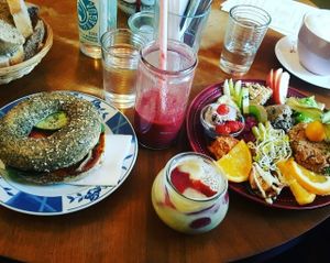 (from left to right) bread that comes with the large breakfast, sweet potato bagel, red berry smoothie, chia pudding, large breakfast at Geh Veg in Berlin