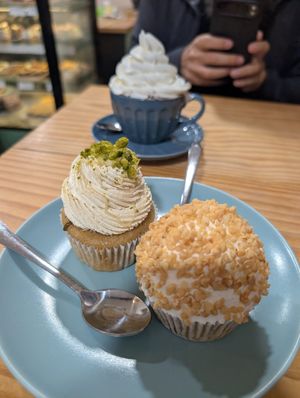 Cupcakes (pistachio and almond/apricot) and hot chocolate with cream at Bohemian Lane in Bilbao