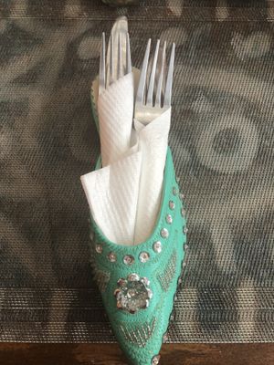 Cutlery arrives in these repurposed shoes at Marrakech Henna Art Cafe in Marrakech