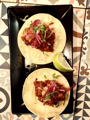 Tacos de jackfruit al pastor con piña asada, @
cebolla encurtida y lima en tortilla de maíz  at VEGA - Luna in Madrid