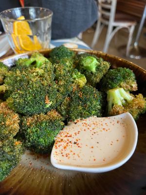 Crispy broccoli with citrus tahini sauce (12€) — very tasty! at VEGA - Luna in Madrid