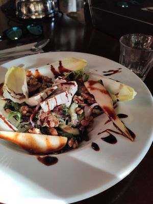 Delicious salad (main dish) with pears, vegan cheese, caramelised walnuts,... at Hagedis in The Hague
