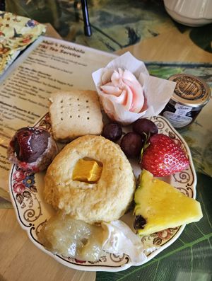 Muir's Holoholo Tiki Tea Service: Mango scone w/ lemon curd & cream, guava cupcake, Hot Lava volcano-coconut stack, Macadamia nut shortbread, tropical fruit at Muir's Tea Room in Sebastopol