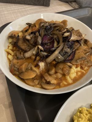 Mushroom stew with gluten free pasta and Seitan steak  at Edeni Vegan in Budapest