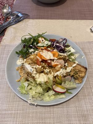 Cauliflower based dish with salad  at Edeni Vegan in Budapest