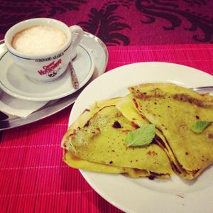 cappuccino with coconut milk and palacsinta pancakes with plumb jam at Edeni Vegan in Budapest