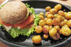 The potatoes were yummy, but the burger was a bit dry and didn't have a lot of flavor. at Nativa in Bogota