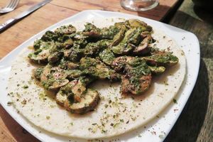 The mushrooms with pesto sauce were nice, but the arepa had no flavor at all. I know basic arepas without filling taste like this, but they could have compensated a bit more with the topping. at Nativa in Bogota