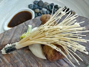 Grill summer mushroom "steak" on pu-ye hot stone. the steak is made of monkey head mushroom which is processed with egg yolk. (Not vegan) at Joie Restaurant in Central Singapore