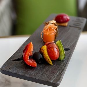 Chef's Selection of Assorted Platter: Salmon sashimi with sea grapes, vegetable skewer, raspberry burst on biscuit  at Joie Restaurant in Central Singapore