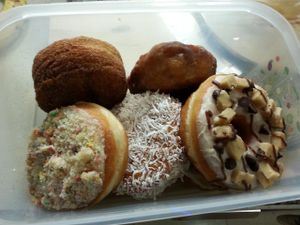 Bring your own Tupperware and get 10% off! From top left...cronut, apple fritter, cookie dough, coconut cream, birthday cake, and chunky monkey (hidden underneath). at Beechwood Doughnuts in St Catharines
