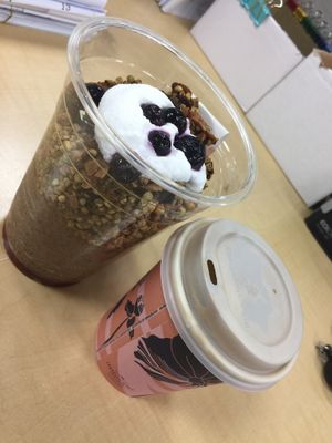 Deluxe breakfast cup & latte w/ in-house made almond milk at The Raw Kitchen in Auckland