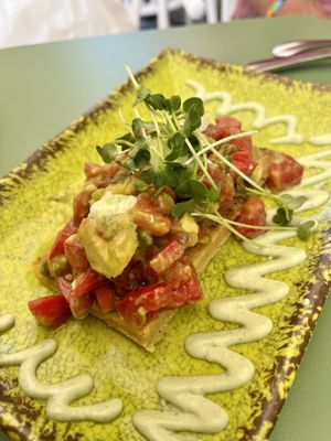 Faina (GF chickpea bread) with avo and tomato + some mayo  at Astrid in Malaga