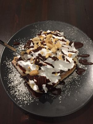 Half a waffle (shared with friends and got two plates) with cream, sauce, banana, peanuts 🥰 at Super Jami Kitchen in Stuttgart