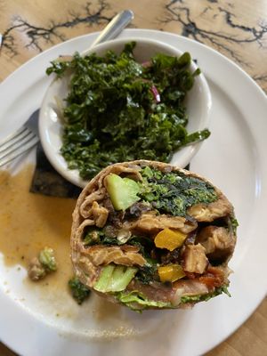 Veggie wrap + tempeh w kale slaw (I ate the other half of the wrap already before this photo 😋)  at The Elusive Cow in Bellevue