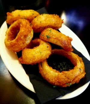 Vegan beer battered onion rings (special order). Their onion rings are not normally vegan.   at The Elusive Cow in Bellevue