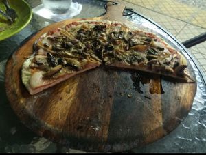 Vegan pizza with mushrooms, veg meat, and veg cheese.  at Oliva Pizzeria in Santiago