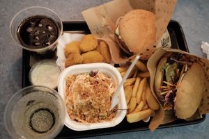First order - vegan nuggets, coleslaw, cherry cola, elderflower, cheese burger, schnitzel burger and mayo dipping sauce at Swing Kitchen - Schottenfeldgasse in Vienna