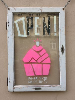 opeimg times and the logo at Cukrárna in Brno