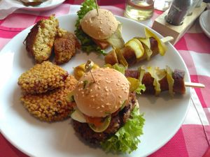 Burgers and sausage with pickles at Kaiserhuettn in Bonn
