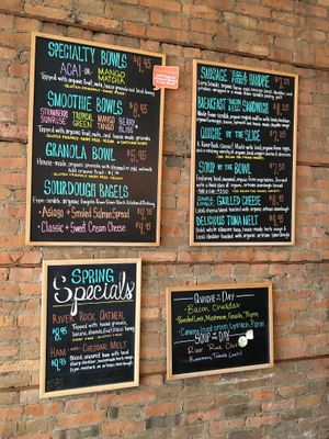 Menu board with clearly labeled vegan items such as smoothie bowls, granola bowls and soups. at River Rock Coffee in St Peter