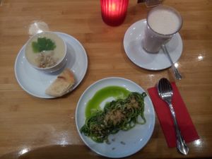 Zucchini pasta with spinach-cashew sauce and pearl barley soup with oat-chai-latte. at Sol in Konstanz