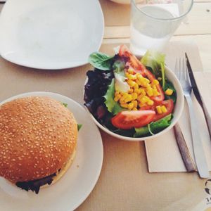 main dish: quinoa burger, side of salad and lemon water at Punto Vegano in Madrid