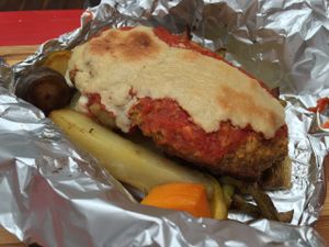 Lentil Meatloaf with cashew cheese and various potatoes backed in foil at Shakti en Chile in Santiago