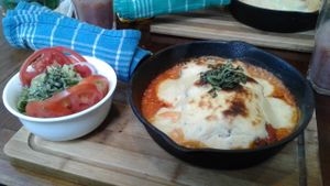 Menu; lasagna and salad at Shakti en Chile in Santiago