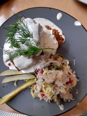 Potato pie, creamy dill sauce, gherkin, sauerkraut with pomegranate seeds at Lokal Vegan Bistro in Warsaw
