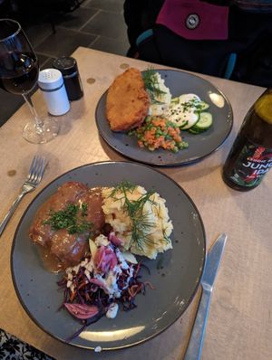 Sausage like thing with pickles inside and schnitzel at Lokal Vegan Bistro in Warsaw
