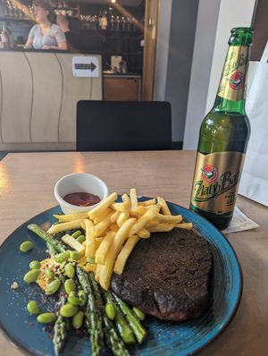 Seitan steak with chips and beer at Lokal Vegan Bistro in Warsaw