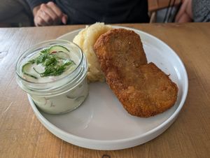 Soy cutlet with mashed potatoes and creamy cucumber and radish at Lokal Vegan Bistro in Warsaw