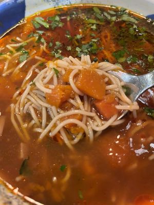 Clear pumpkin soup with noodles. at Lokal Vegan Bistro in Warsaw