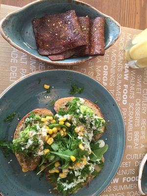 Avocado on toast with kale, corn and tahini. Side of tempeh bacon  at Passion - Santa Eulalia in Ibiza