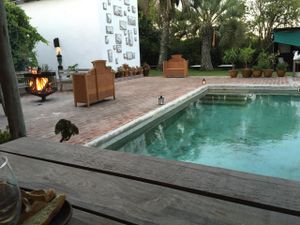 Outside seating near pool with fire at Garzon Restaurant in Garzon