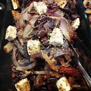 onions with sundried tomatoes, olives and balls of vegan ricotta with sesame seeds at Giumella in Florence