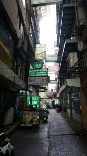 Under the green sign is the entrance at Guptaji Ki Kitchen in Bangkok