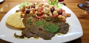 Main course! Very tasty pesto steak w/ empanada and beans at Amaranto in Guayaquil