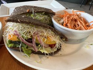 Raw sandwich with onion bread and coleslaw  at Eternal Abundance in Vancouver